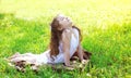 Child doing yoga exercise stretching on grass in sunny summer Royalty Free Stock Photo