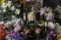 Child doll surrounded by flowers