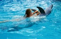 Child and dolphins in blue water. Dolphin Assisted Therapy Royalty Free Stock Photo