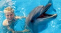 child and dolphins in blue water. Dolphin Assisted Therapy Royalty Free Stock Photo