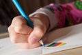 Child drawing with blue pencil Royalty Free Stock Photo