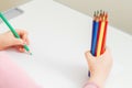 Child is drawing by colored pencils Royalty Free Stock Photo