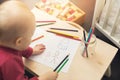 Child drawing family picture with colored pencils Royalty Free Stock Photo