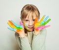 Child drawing. Happy girl art school student with bright painted hands on white background Royalty Free Stock Photo