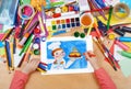 Child drawing holiday cake and cook, top view hands with pencil painting picture on paper, artwork workplace Royalty Free Stock Photo