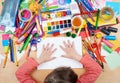 Child drawing top view. Artwork workplace with creative accessories. Flat lay art tools for painting. Royalty Free Stock Photo