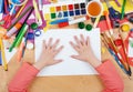 Child drawing top view. Artwork workplace with creative accessories. Flat lay art tools for painting. Royalty Free Stock Photo