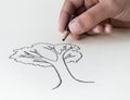 A child drawing a tree with a very short pencil stubÃÅ expressin