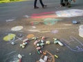 Child drawings on grey asphalt concrete.