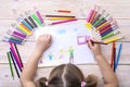A child draws a birthday card with his family. Drawing made by a child with colorful felt-tip pens and pencils. Happy family. Royalty Free Stock Photo