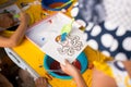 A child draws with colored sand picture. Cartoon characters.