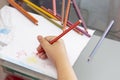 Child draws with colorful pencils. Children`s drawing on theme of fishing with goldfish, car Royalty Free Stock Photo