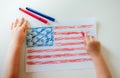 The child draws the flag of America. Royalty Free Stock Photo