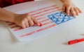 The child draws the flag of America. Royalty Free Stock Photo