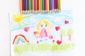 A child draws a postcard for mother's day. Beautiful landscape with mom drawn with pencils. Royalty Free Stock Photo