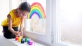 A child draws a rainbow sign of hope on a window Royalty Free Stock Photo