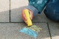 A child draws the Ukrainian flag with chalk on the pavement Royalty Free Stock Photo