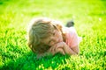 Child dream in park outdoor. Spring kid lying on grass. Summer boy walk. Warm summer day during school holidays. Kid boy Royalty Free Stock Photo