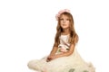 Child in a dress sitting on the floor