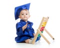 Child dressed in academic clothes with counter. Early kids education. Royalty Free Stock Photo