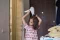 The child dries his hair with a hair dryer