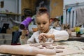 The child dries the molded product with a hairdryer