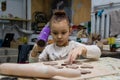 The child dries the molded product with a hairdryer