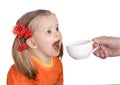 Child drink water from white cup.