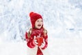 Child drinking chocolate on Christmas in snow Royalty Free Stock Photo