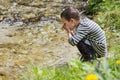 Child drinking clean river water Royalty Free Stock Photo