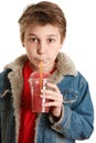 Child drinking fresh fruit juice through a straw Royalty Free Stock Photo