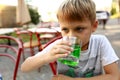 Child drinking green lemonade