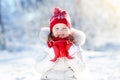 Child drinking hot chocolate in winter park. Kids in snow on Christmas. Royalty Free Stock Photo