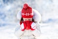 Child drinking hot chocolate in winter park. Kids in snow on Christmas. Royalty Free Stock Photo