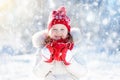 Child drinking hot chocolate in winter park. Kids in snow on Christmas. Royalty Free Stock Photo