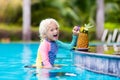 Child drinking juice in swimming pool bar Royalty Free Stock Photo