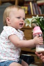 Child drinking milk from bottle, adorable and cute baby Royalty Free Stock Photo