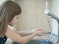 Child drinking water in kitchen at home. Thirsty baby. Hands open for drinking tap water. Pouring fresh drink. Water quality check Royalty Free Stock Photo