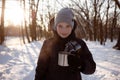 A Child Drinks Hot Chocolate Or Cocoa In A Snowy Winter Park. Cute Boy Holding A Cup Of Hot Drink And Smiling