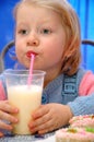 Child drinks milkshake from straw