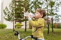 Child drinks water from a bottle in the open air