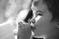 Child drinks water from a bottle while walking, baby health. Boy bottle of water. Young boy holding drink fresh water Royalty Free Stock Photo