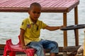 Child driving a Boat Laos Royalty Free Stock Photo