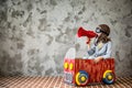 Child driving in a car made of cardboard box