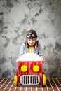 Child driving in a car made of cardboard box