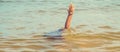 A child drowns in water at sea. Selective focus