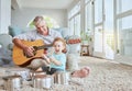 Child drummer with grandfather, guitar and music playing with pot drums in the living room at house. Happy, excited and Royalty Free Stock Photo