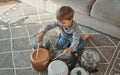 Child drummer having fun drum playing on kitchen pans at home Royalty Free Stock Photo