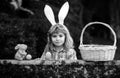 Child with easter eggs in basket outdoor. Happy easter day. Child with bunny ears. Easter egg hunt. Fynny kids portrait. Royalty Free Stock Photo