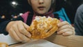 Child eat pizza cheese four. Close up of young girl woman eating pizza and chewing in outdoor restaurant. Kid children Royalty Free Stock Photo